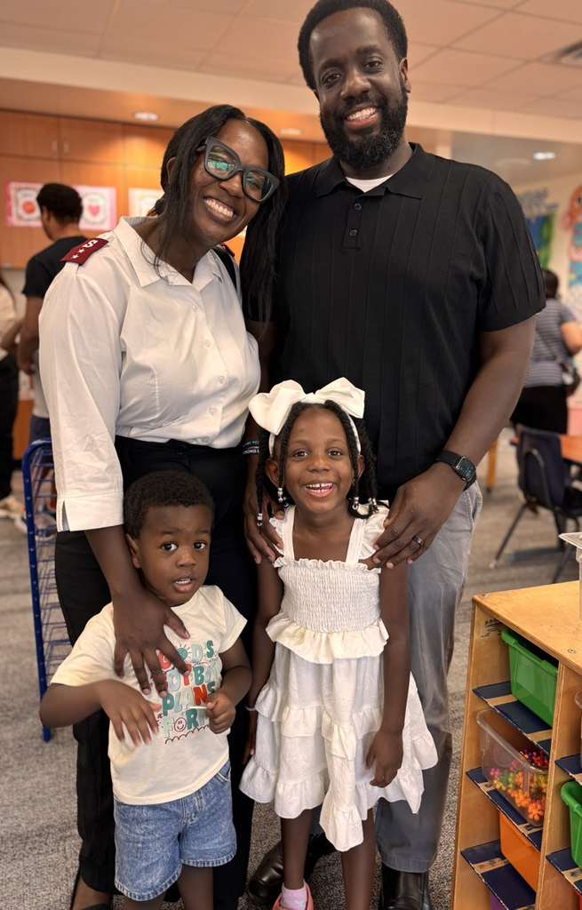 family posing for a photo in kindergarten pod 