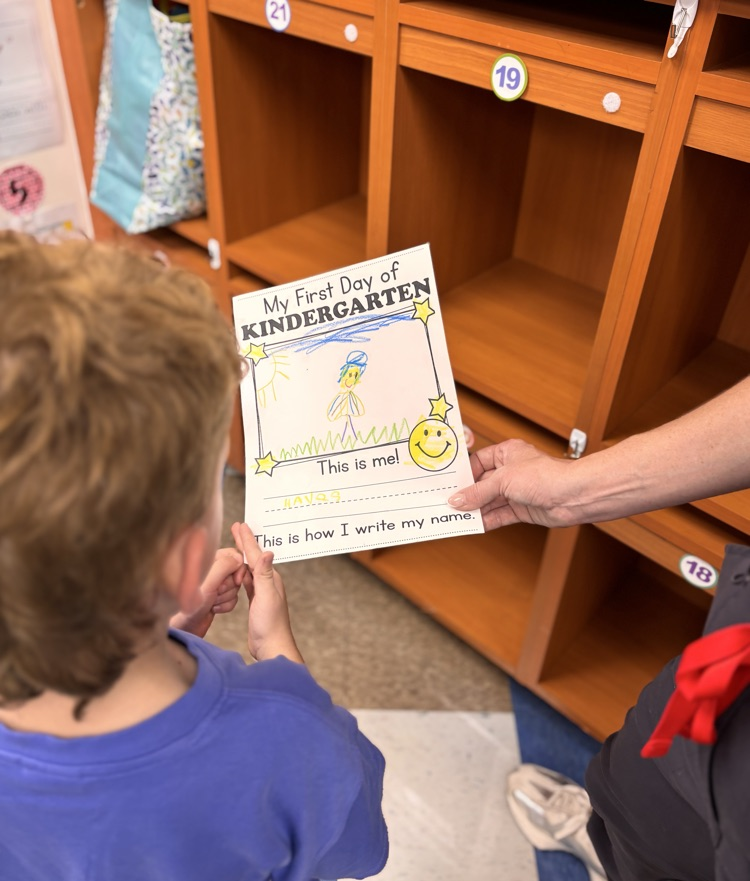 student looking at paper with parent 