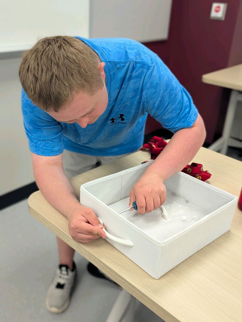 An intern building a shelf