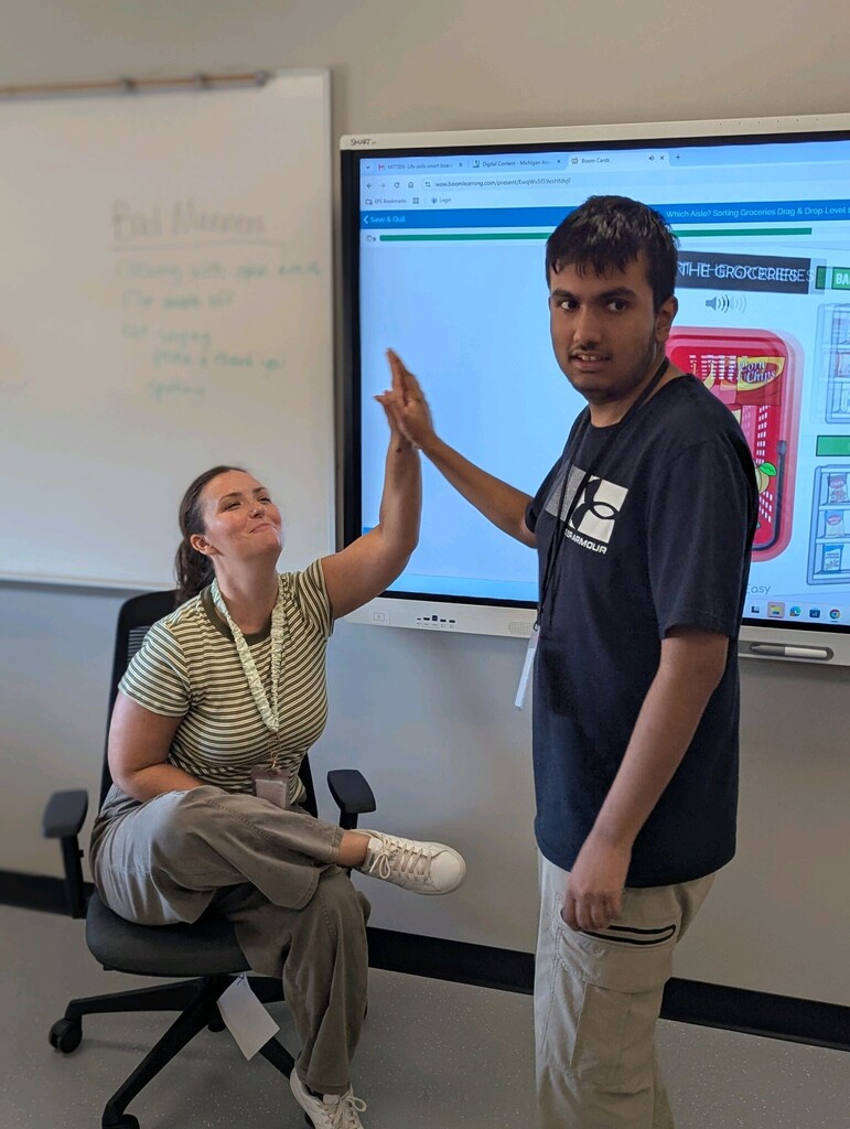 An intern working at the Smartboard
