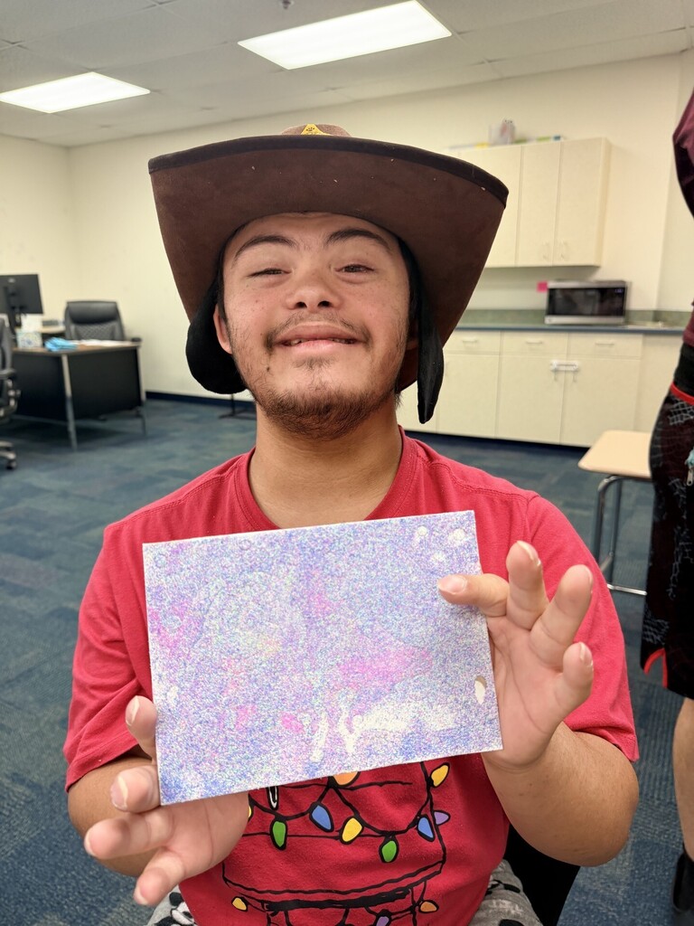 An intern showing off his artwork 