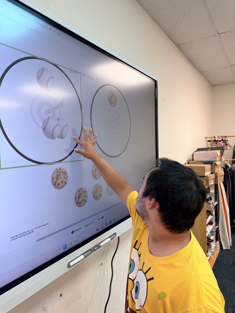 An intern working at the Smartboard