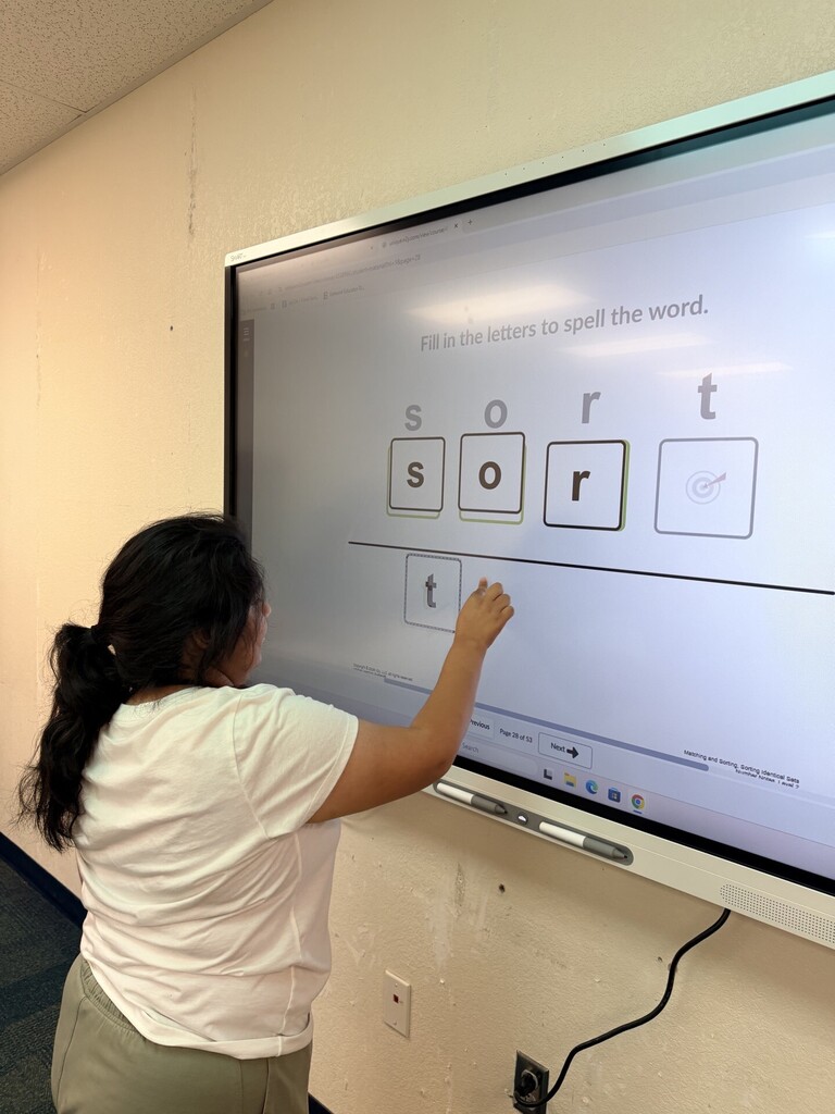 An intern working at the Smartboard
