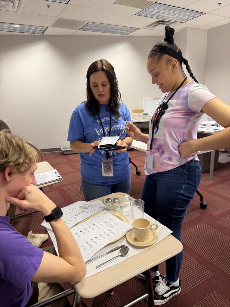 Interns and a teacher practicing Table Service