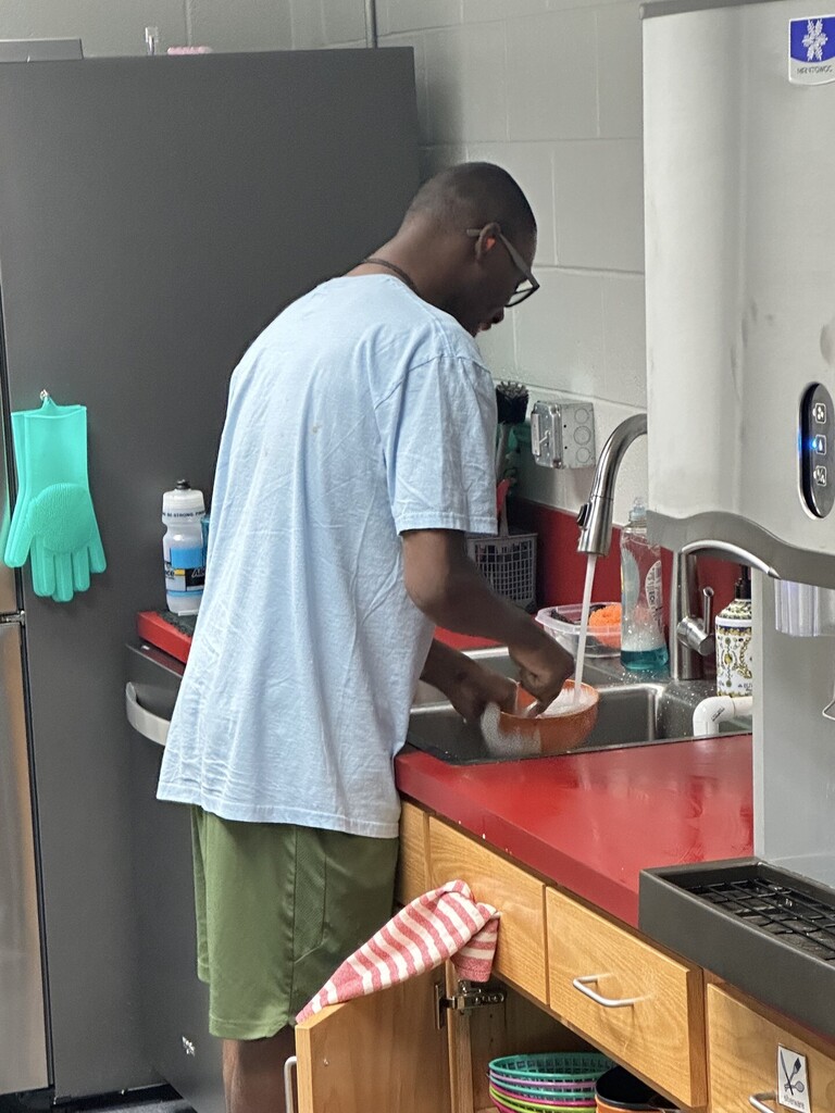 An intern washing dishes