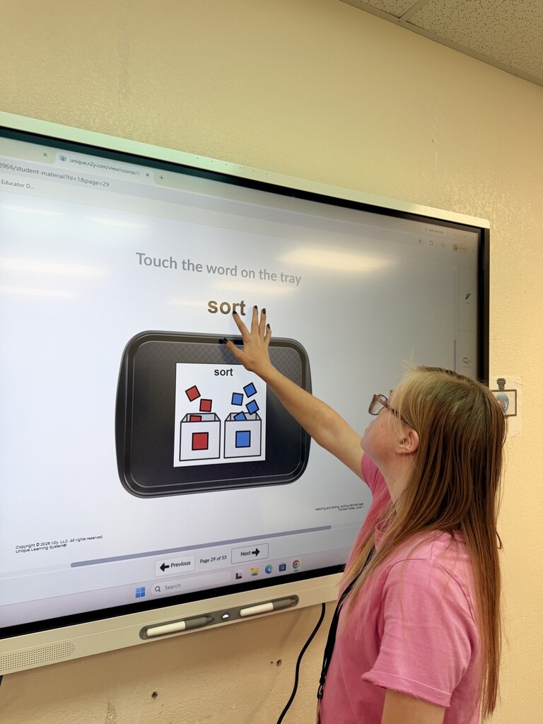 An intern working at the Smartboard