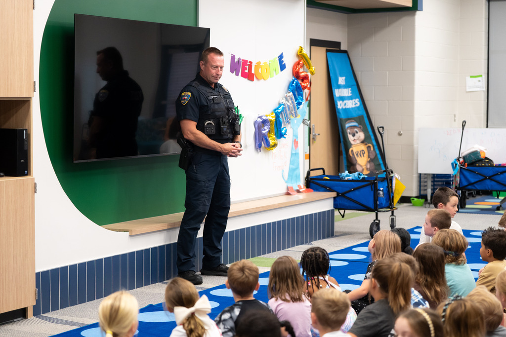 police officer talking to students