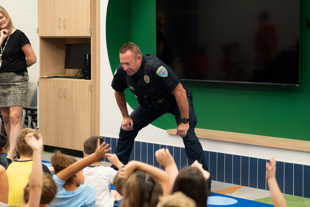 police officer talking to students