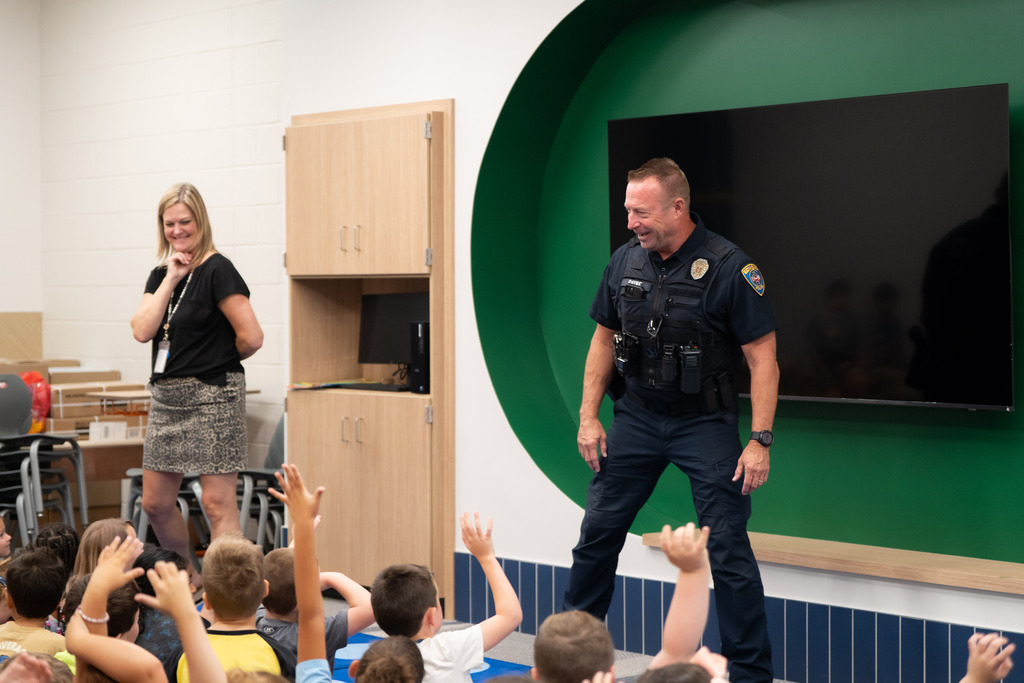 police officer talking to students