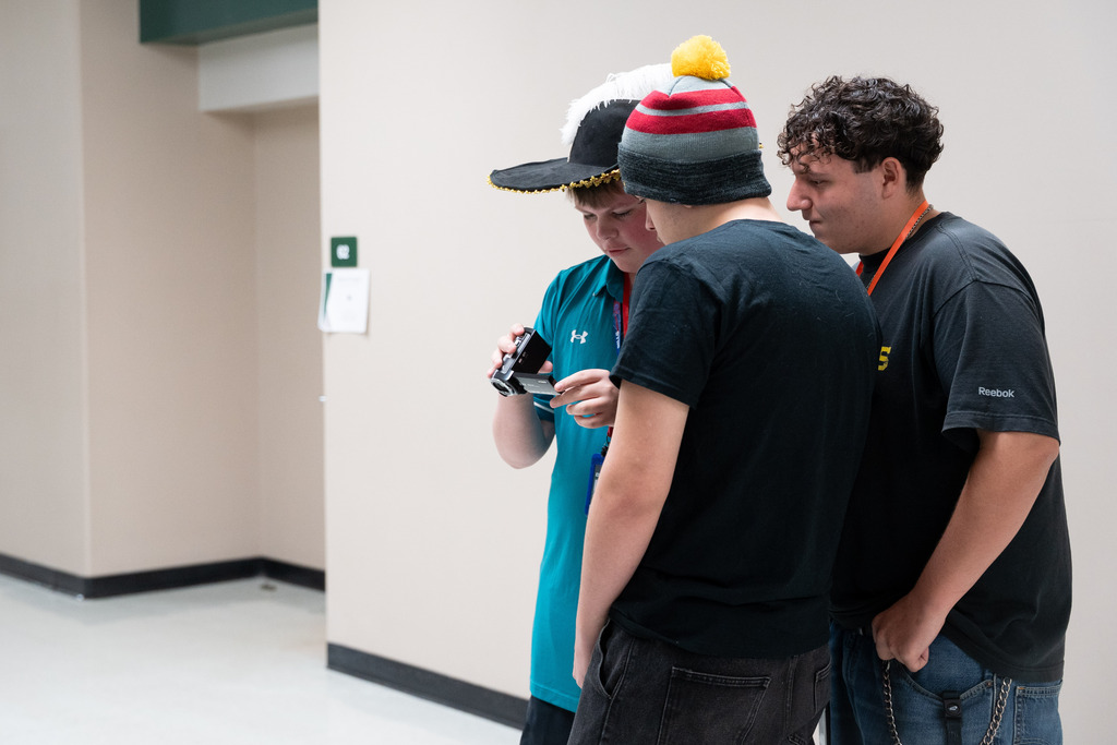 students looking at a camera screen