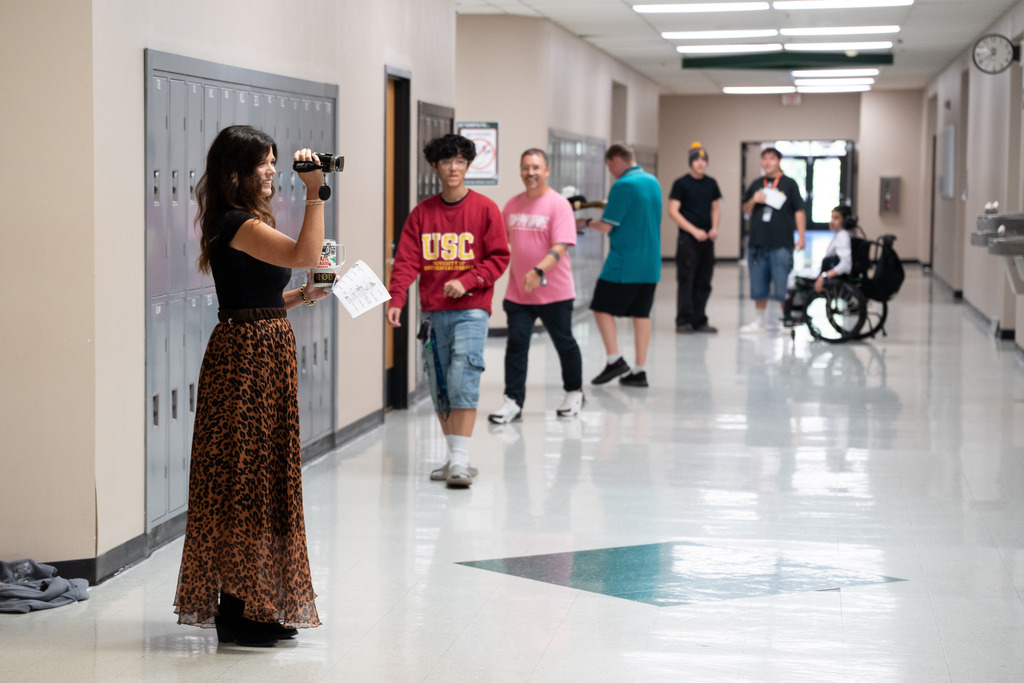 teacher filming students for class