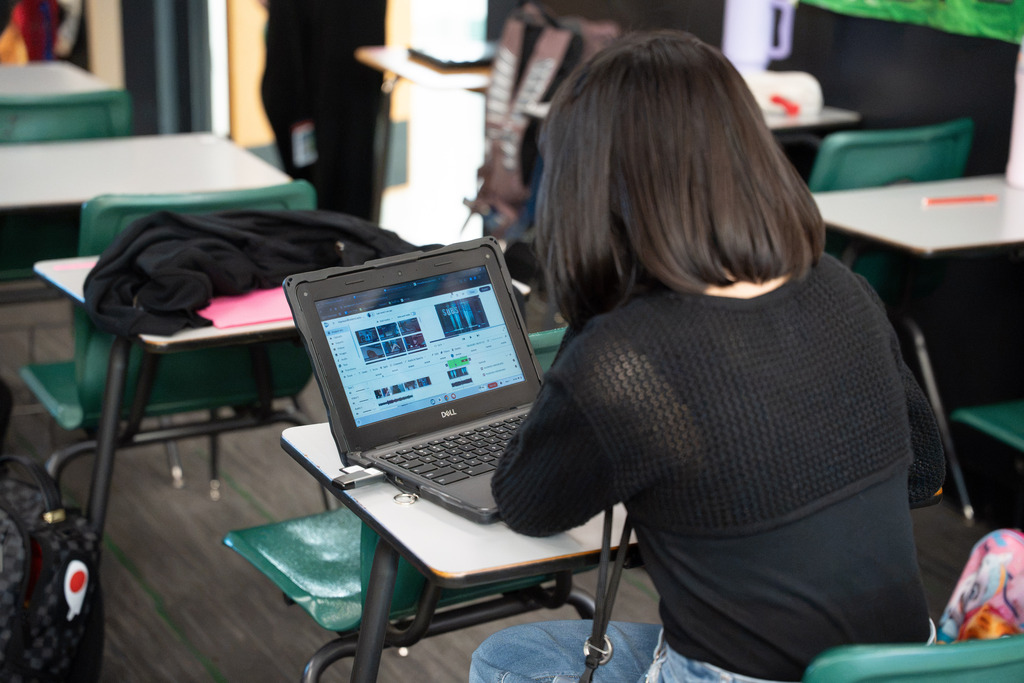 overhead of a girl looking at her computer