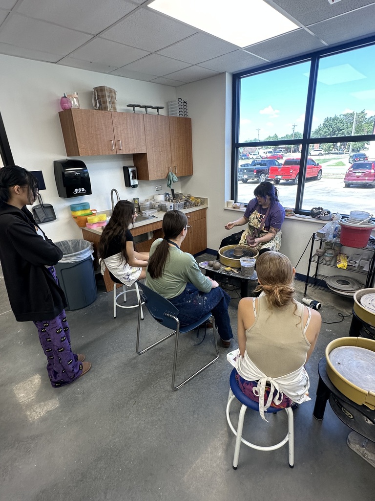 High School Art Students Learning to Throw Clay on the Pottery Wheel.