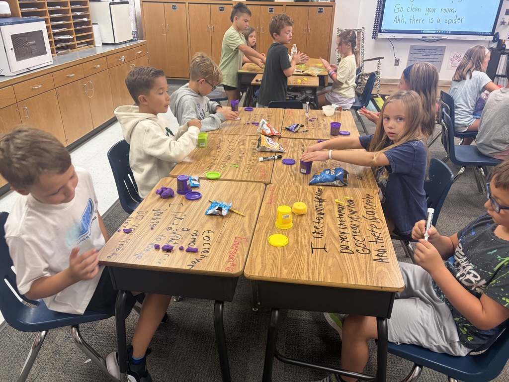 Kids working at desks.