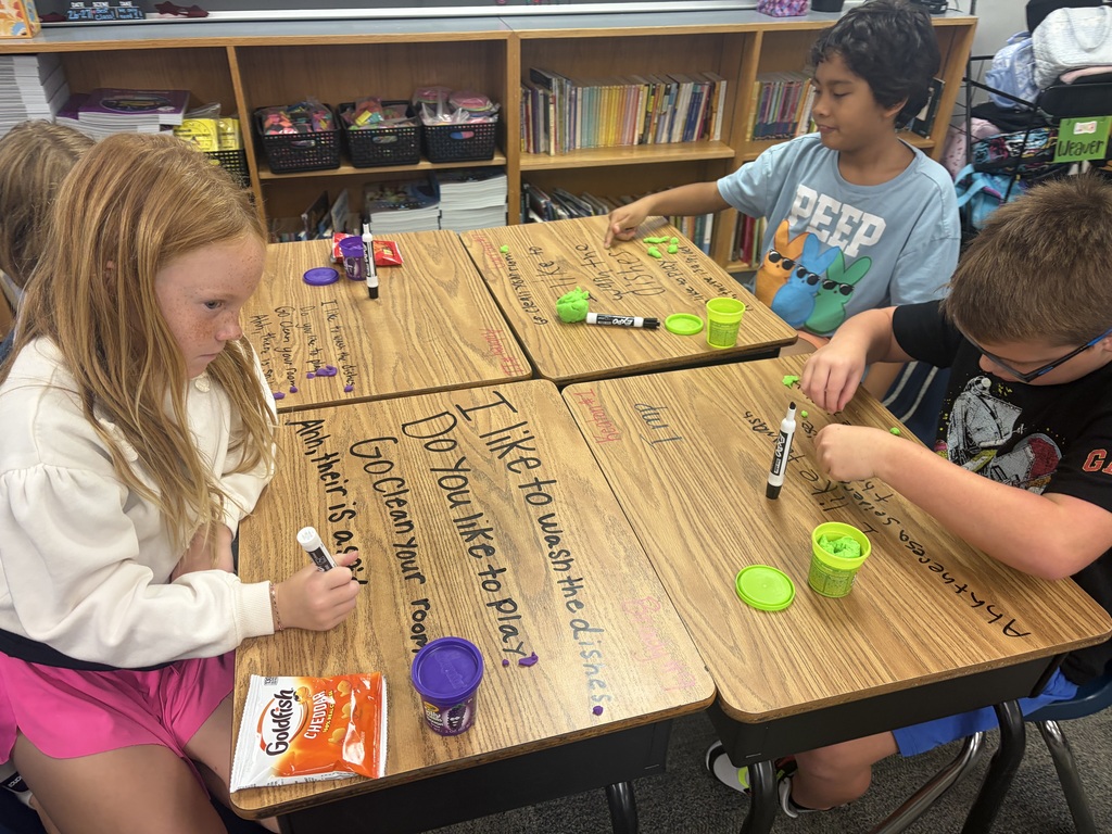 Kids working at desks.