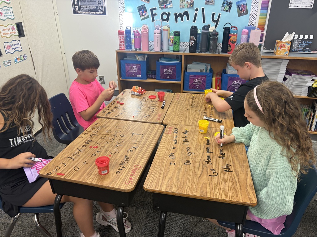 Kids working at desks.