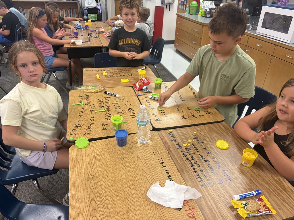 Kids working at desks.