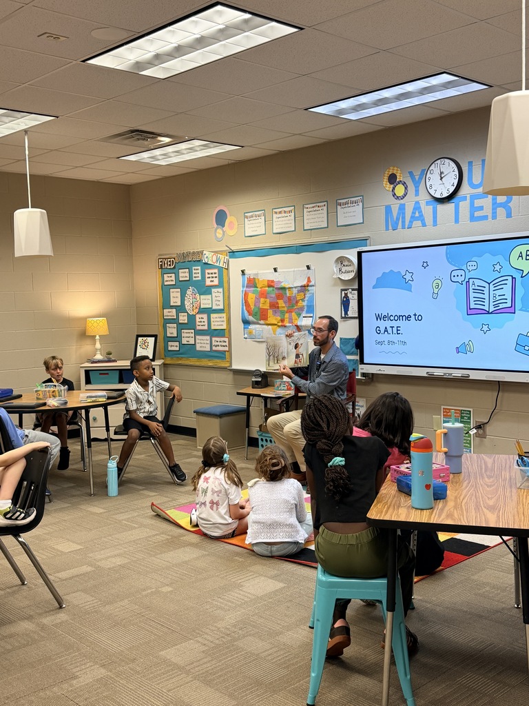 Gentleman reading book to class
