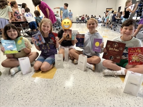 Students with their prizes at the summer reading party.
