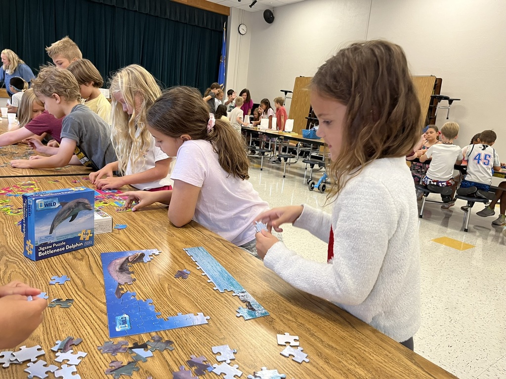 Students working puzzles at the summer reading party.