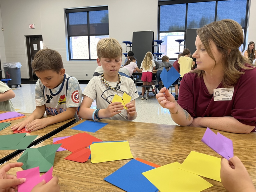 Students folding origami at the summer reading party.
