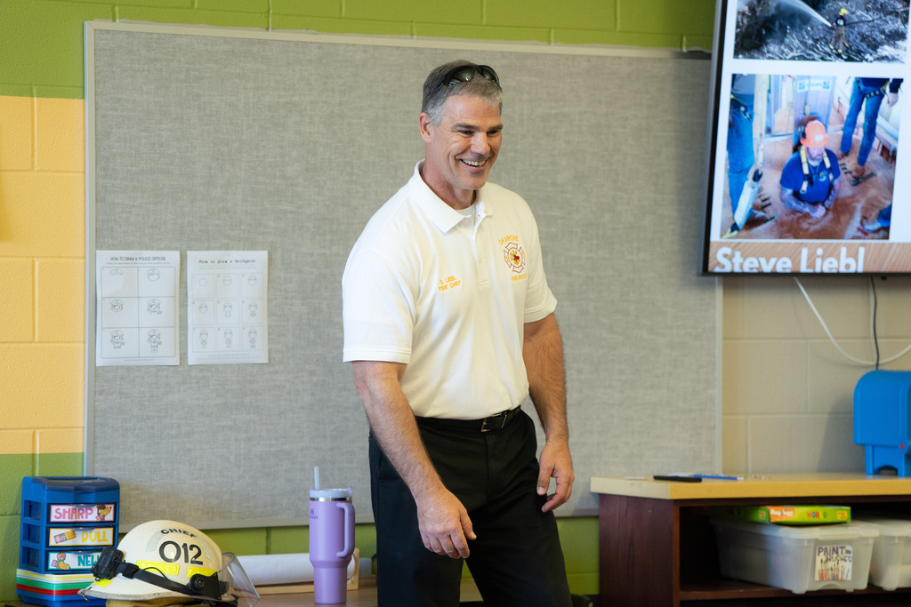  parent talking at the front of the room about their job to students