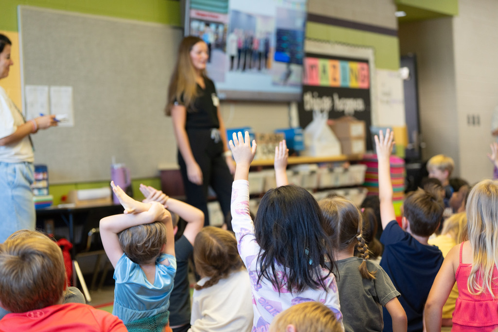 students raising their hands