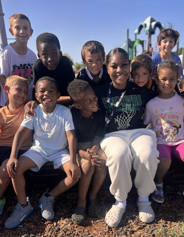 students with basketball player at recess 