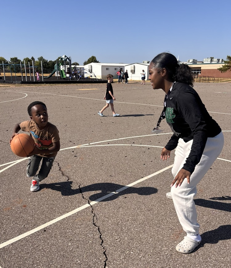 student playing basketball with basketball player 