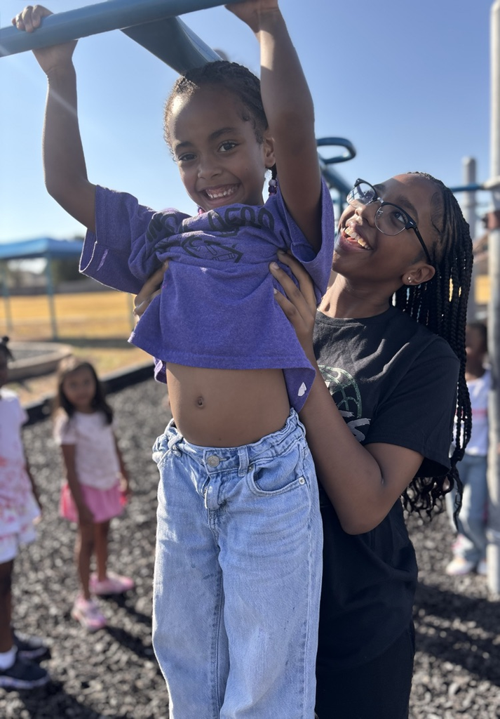 basketball player helping girl on monkey bars 