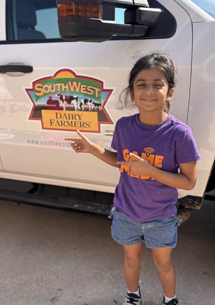 student in front of dairy farm truck 