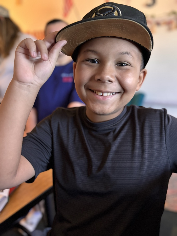 fourth grader with his hat 