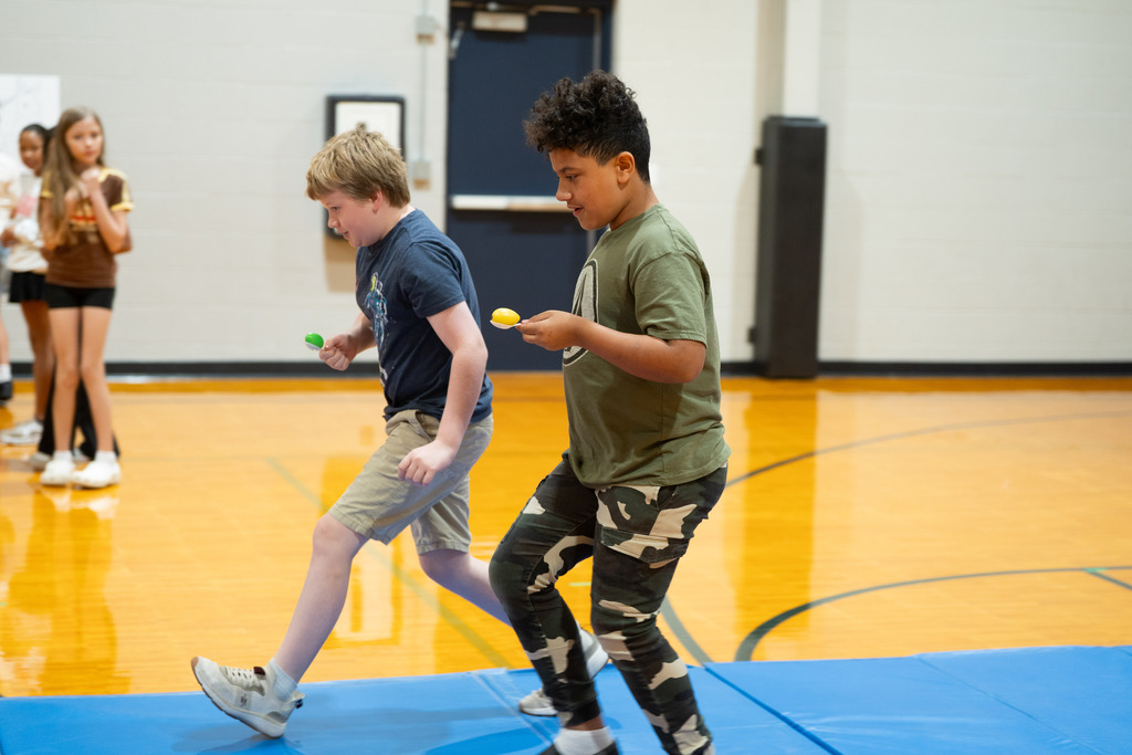 students participating in an egg race