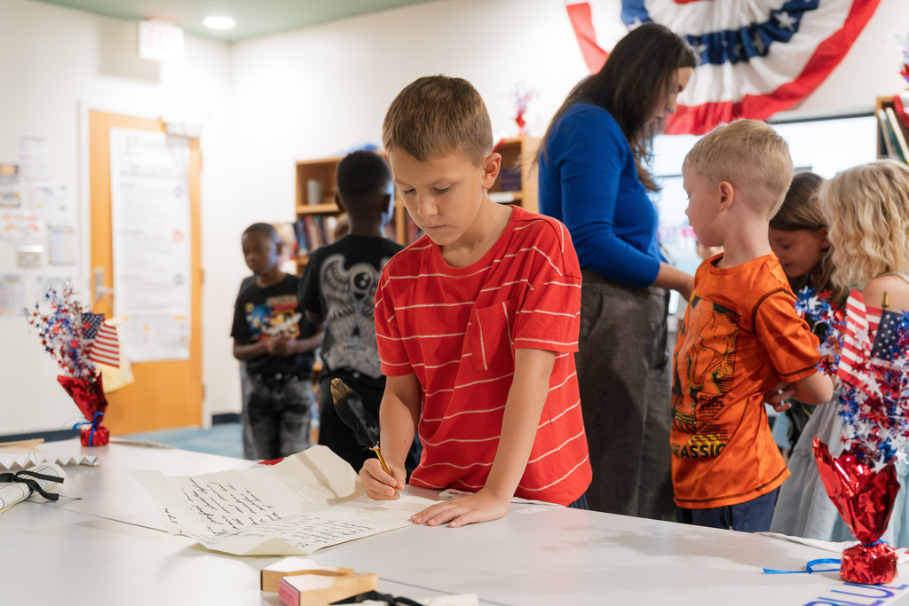 student signing a replica constitution