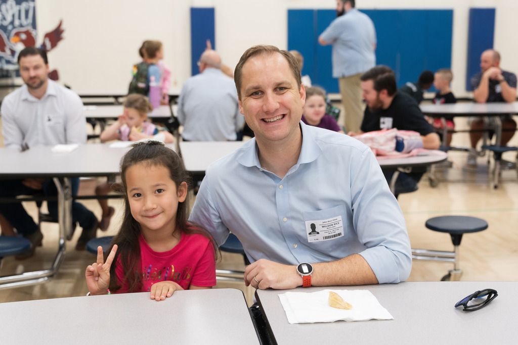students smiling with their dad