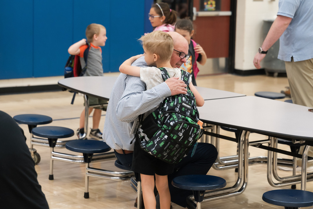 student and dad hugging