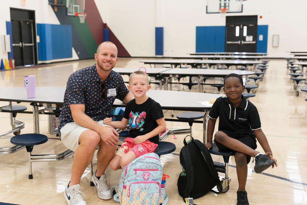 students smiling with their dad