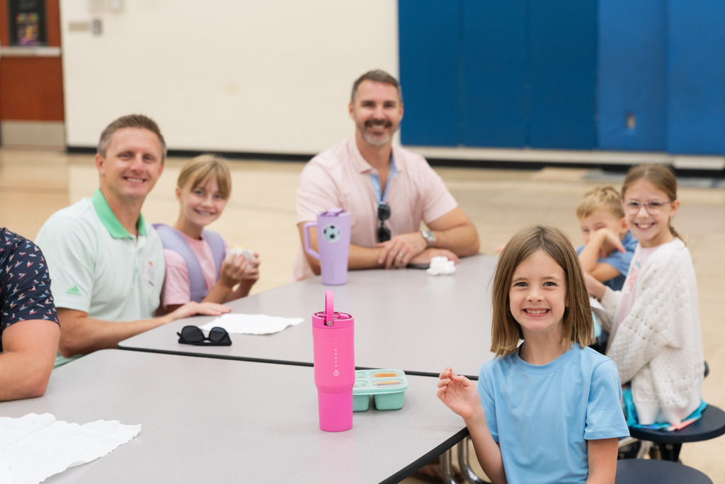 students smiling with their dad