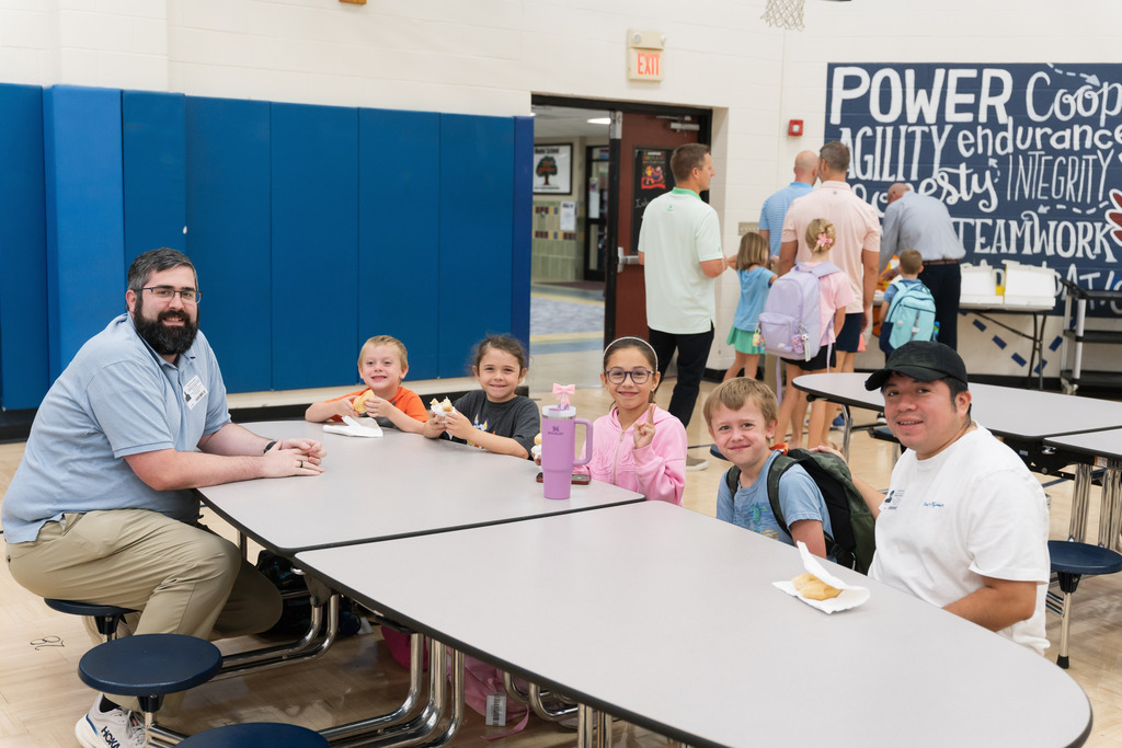 students smiling with their dad