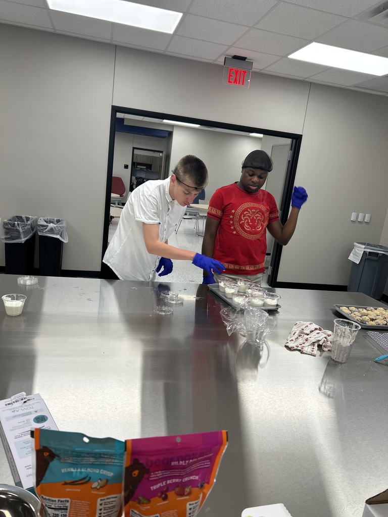 Interns putting yogurt in parfait cups
