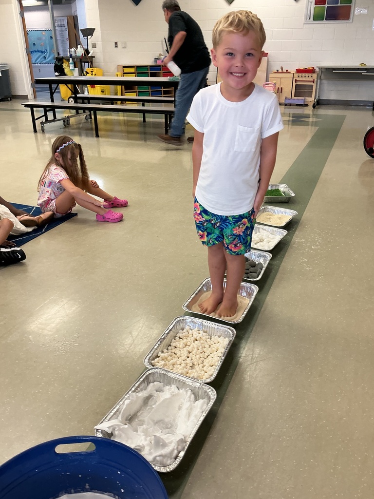 Student standing in sand.