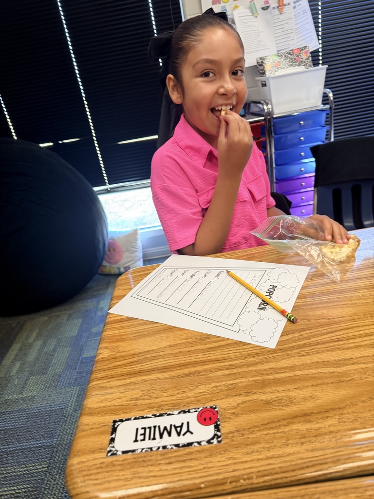 kid eating popcorn and doing work