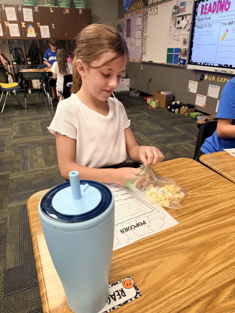 kid eating popcorn and doing work