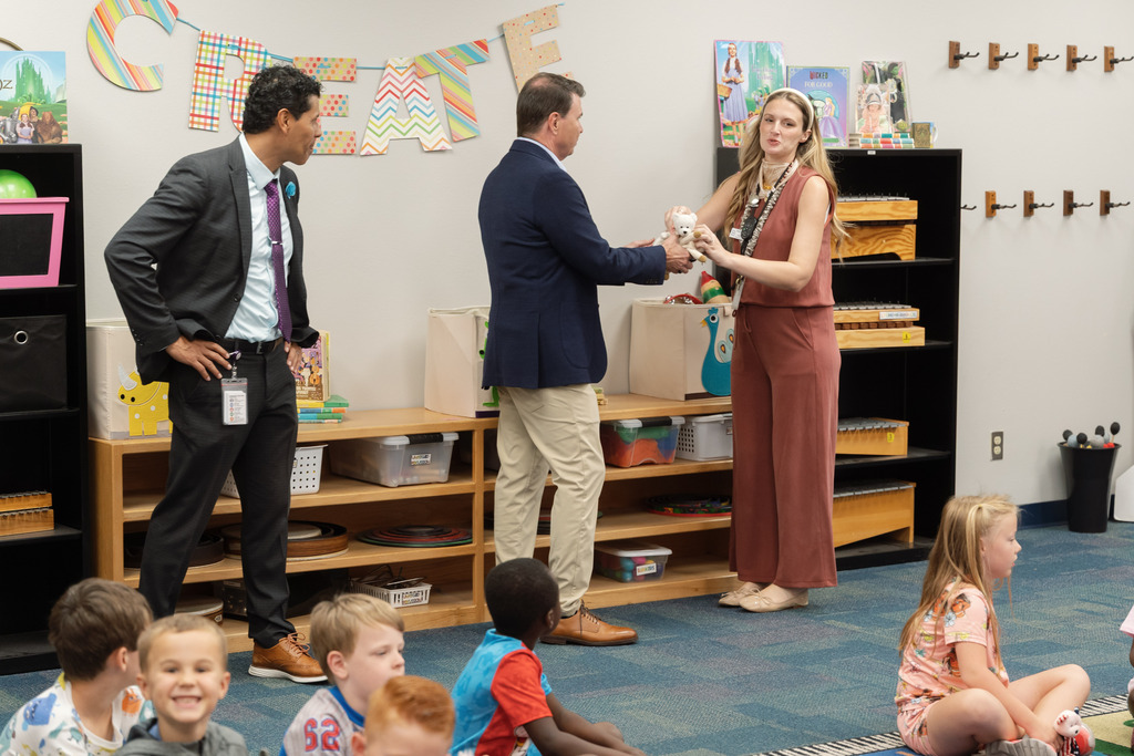 state superintendent working with teacher