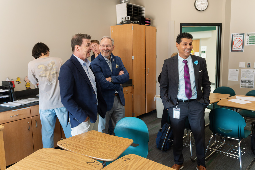 administrators talking to a teacher