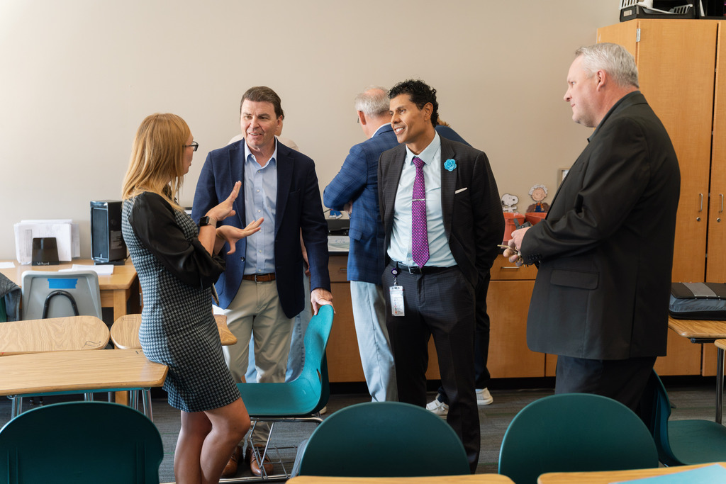 administrators talking to a teacher