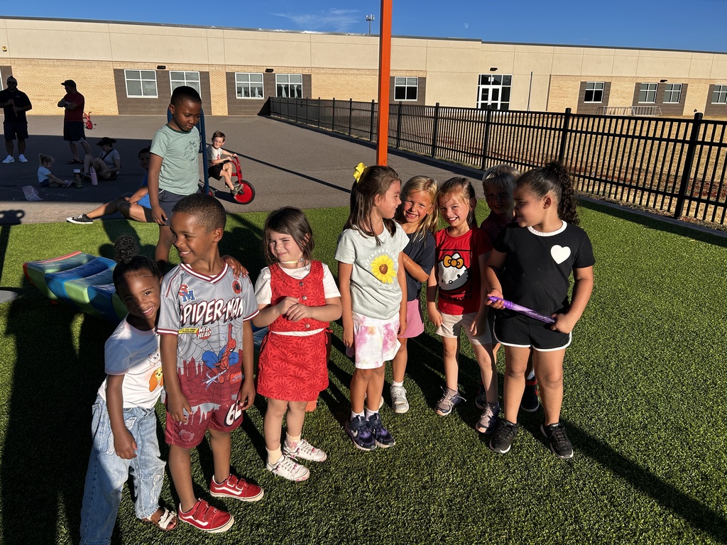 Kindergarten students playing on the playground together