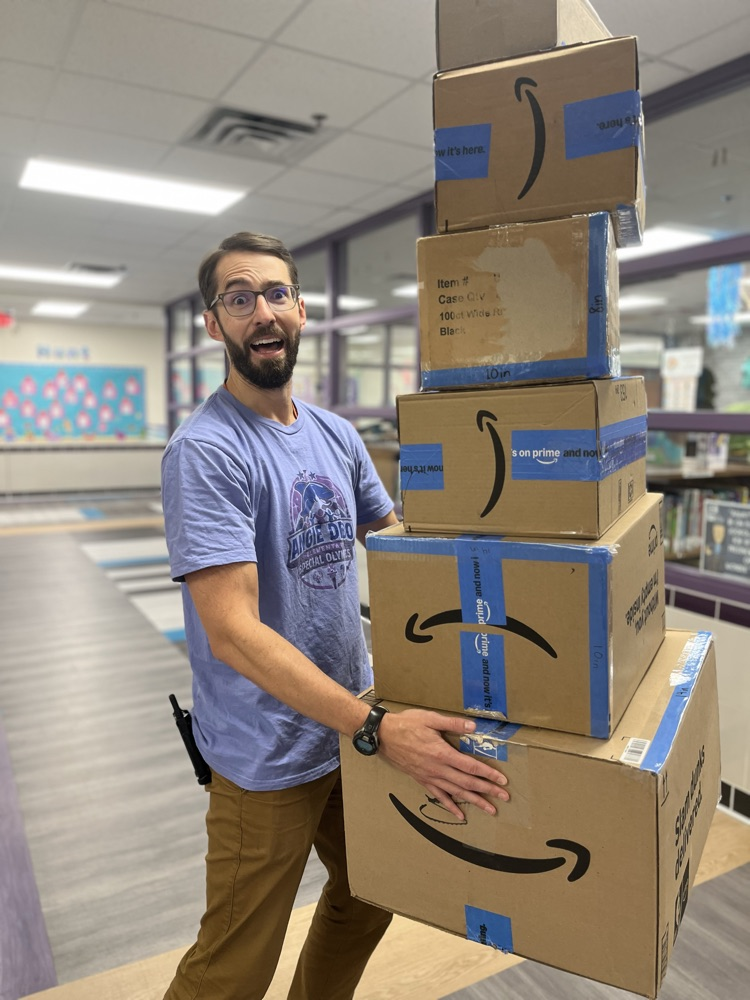 Mr. Goodrich carrying Amazon boxes 