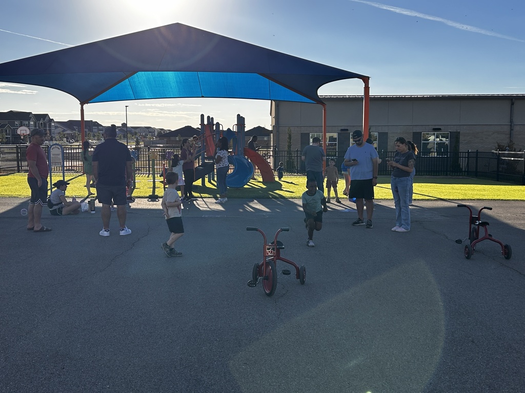 Kindergarten families meeting on the playground.