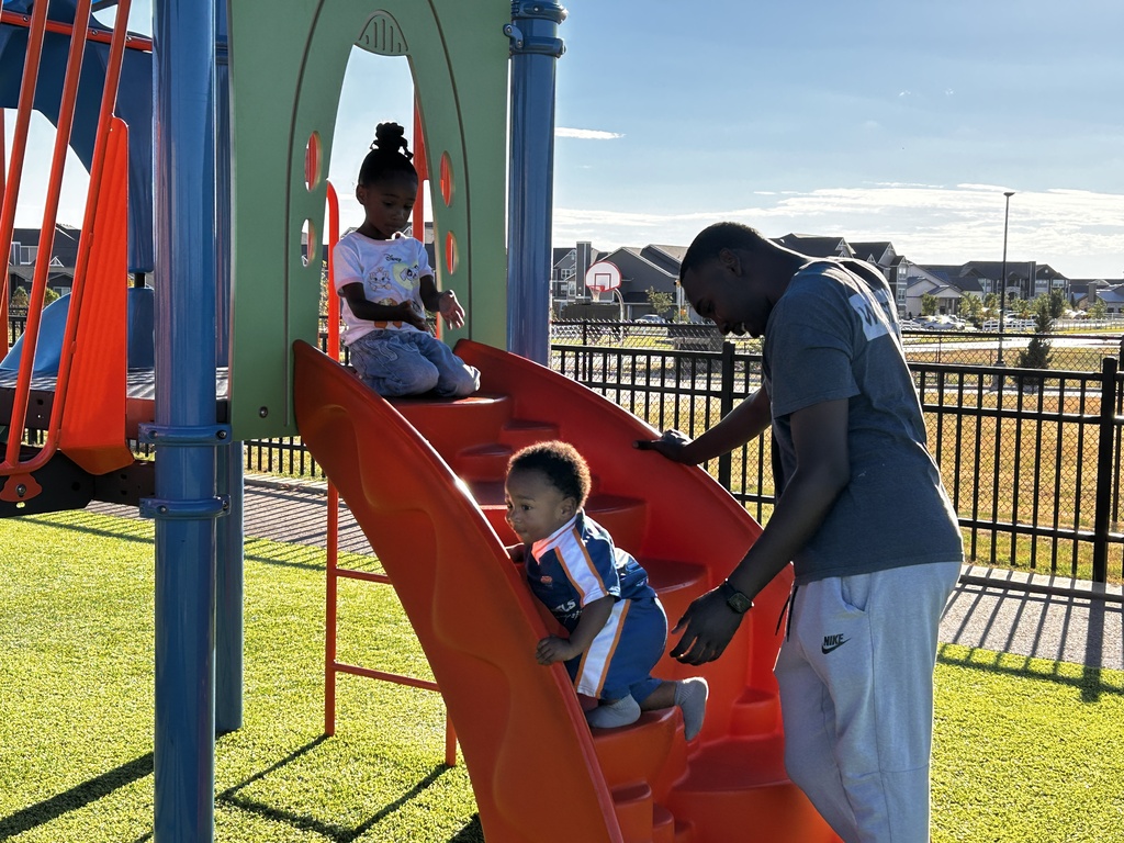 Siblings of kindergarten students enjoying the playground.